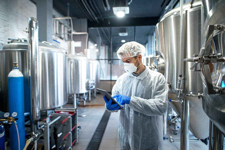 Technician inspecting equipment in a speciality materials facility